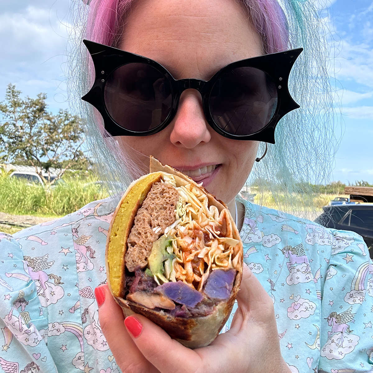 me holding half of a killer breakfast burrito from Rainbow Kitchen in Maui.