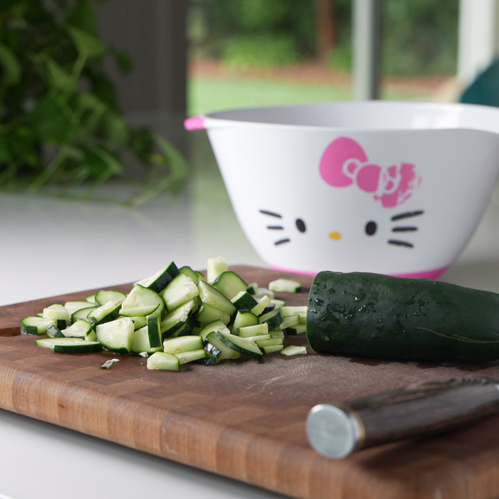 dicing a cucumber on a  cutting board