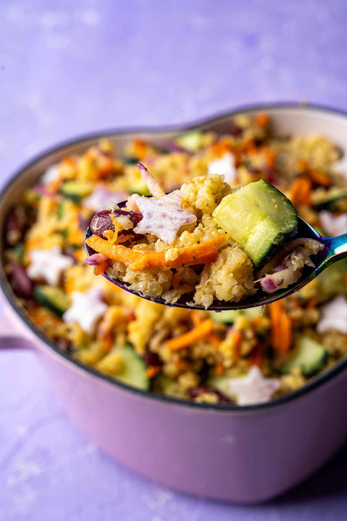 a bite of millet and quinoa salad on a spoon with the rest in the background