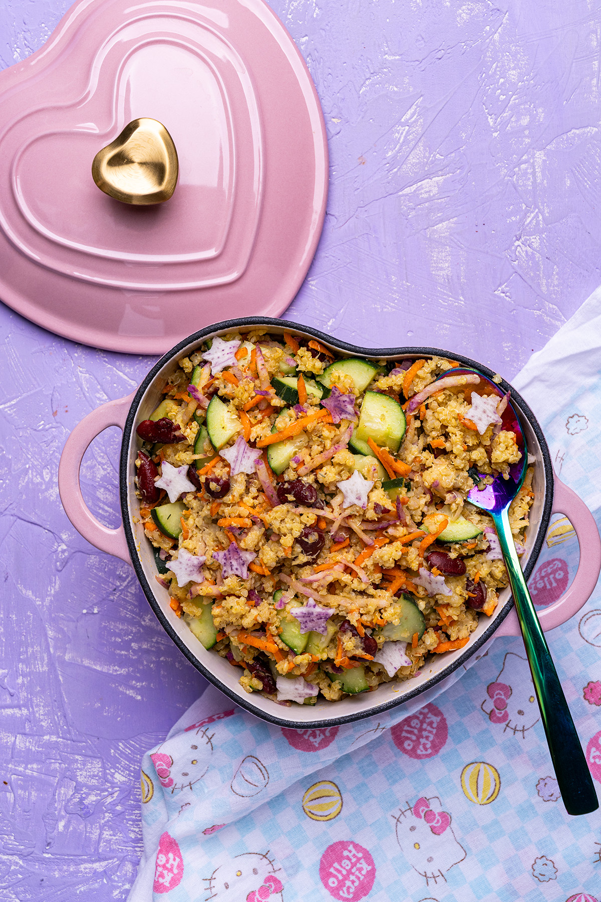 overhead shot of a pink heart dutch oven filled with vegan millet salad