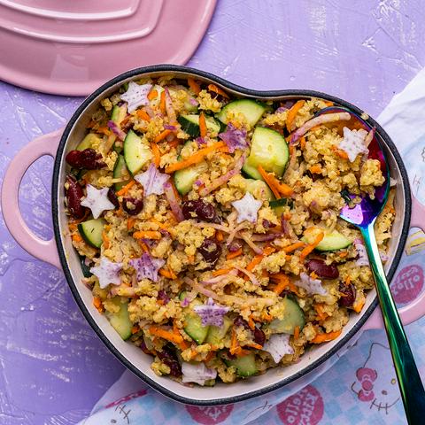 overhead shot of a pink heart dutch oven filled with vegan millet salad