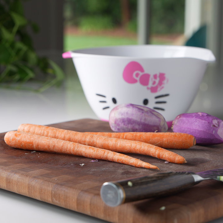 carrots and peeled purple daikon on a cutting board