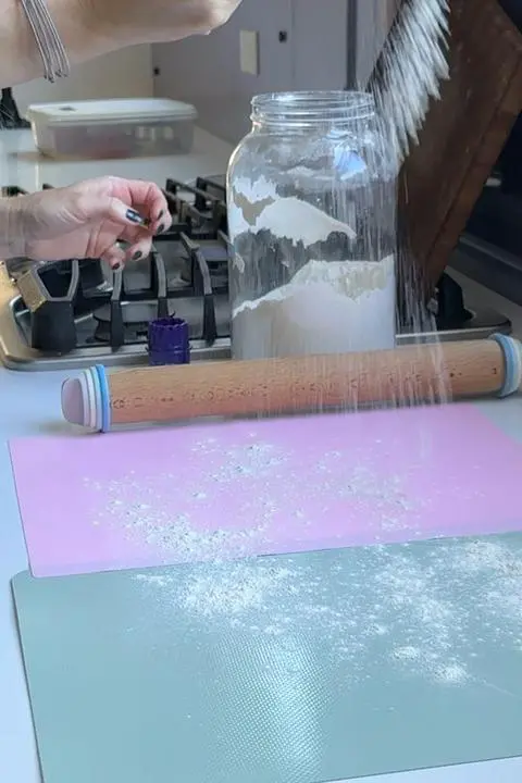 sprinkling flour onto silicone rolling mats.