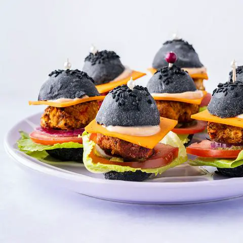 a plate filled with mini veggie burger appetizers.