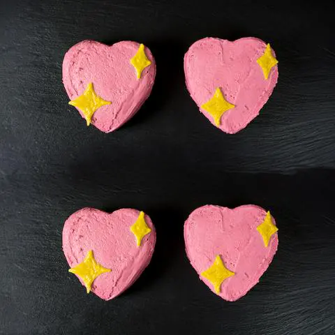 4 mini vegan pink heart cakes that look like a sparkle heart emoji