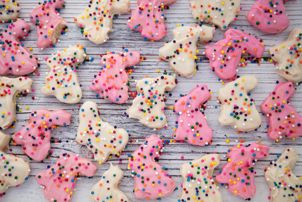 pink and white bunny shaped cookies with sprinkles.