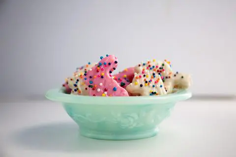 vegan pink and white cookies with sprinkles in a bowl