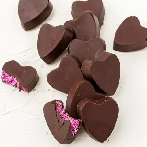 vegan heart-shaped mounds candy with a bite missing from one