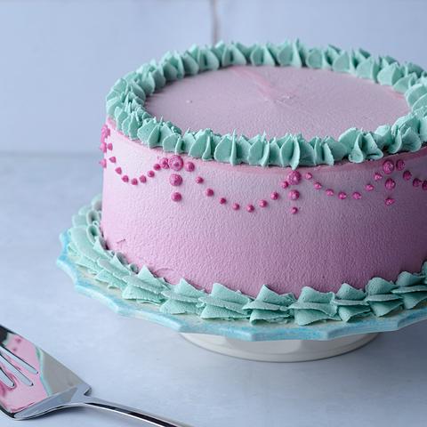 vegan nutella cake decorated with pink and teal frosting