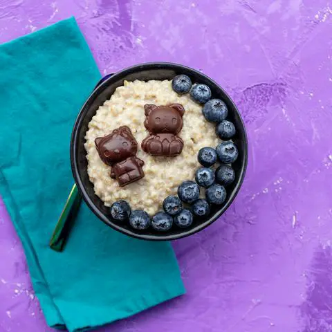 bowl of steel cut oatmeal with hello kitty chocolates and blueberries