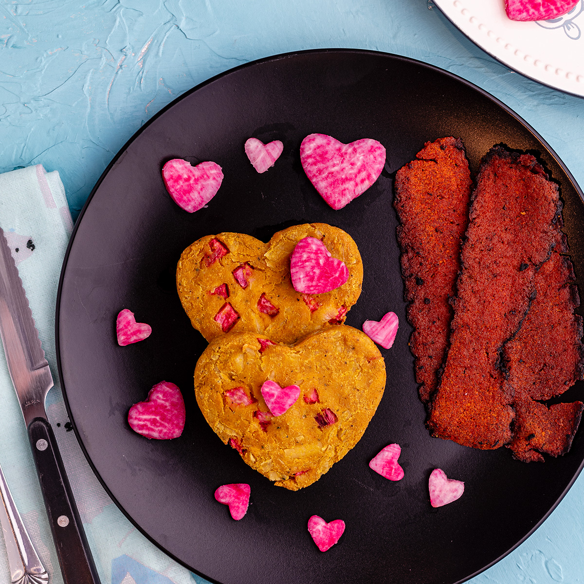 heart shaped Vegan Air Fryer Omelettes on a plate with vegan bacon