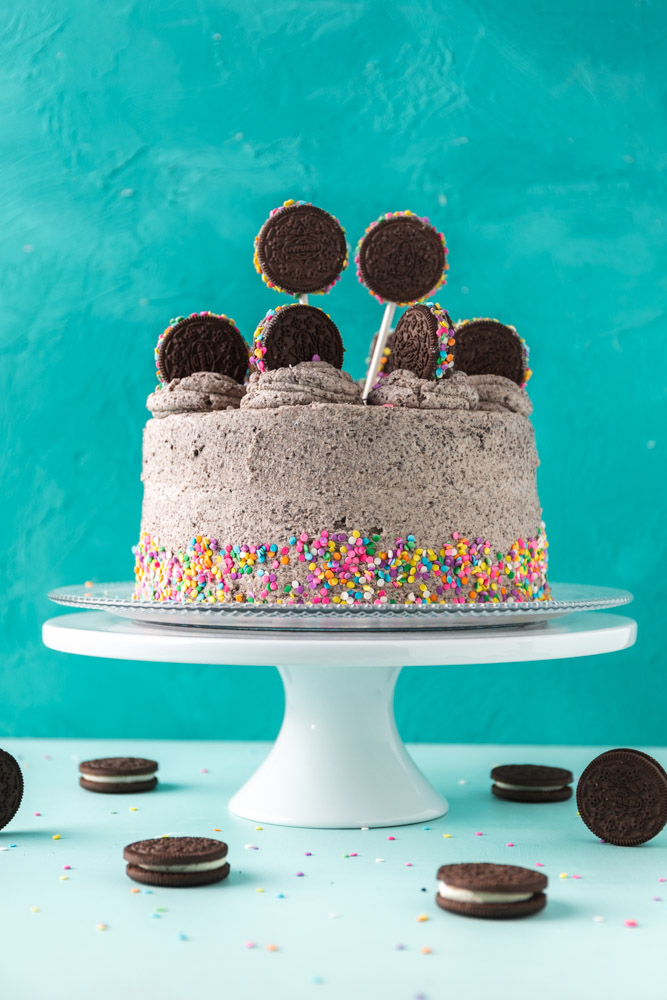 vegan cookies and cream cake decorated with sprinkles and newman O sandwich cookies