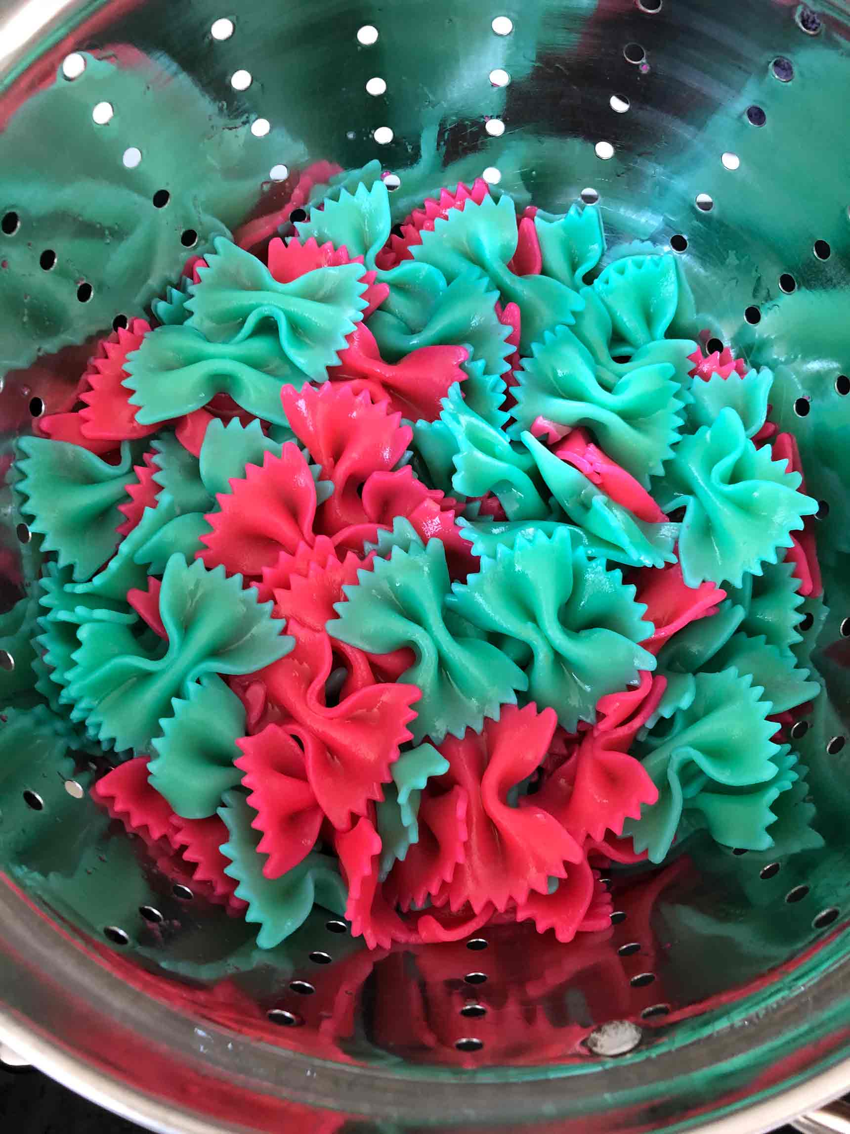 pink and blue pasta in the colander