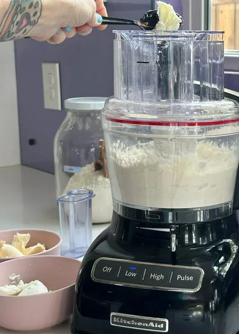 adding small amounts of vegan butter to the food processor while it’s running.