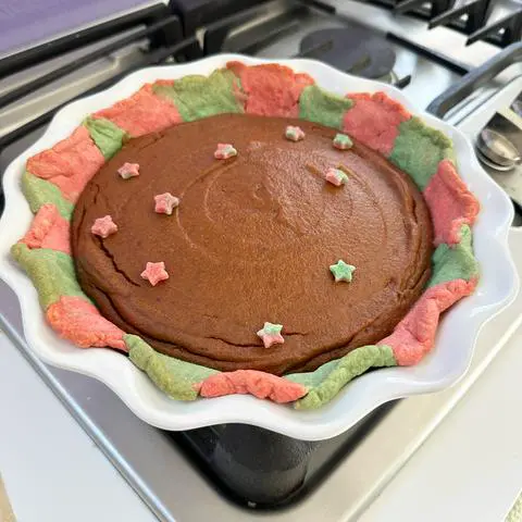 vegan pumpkin pie baked in the christmas colored pie crust.