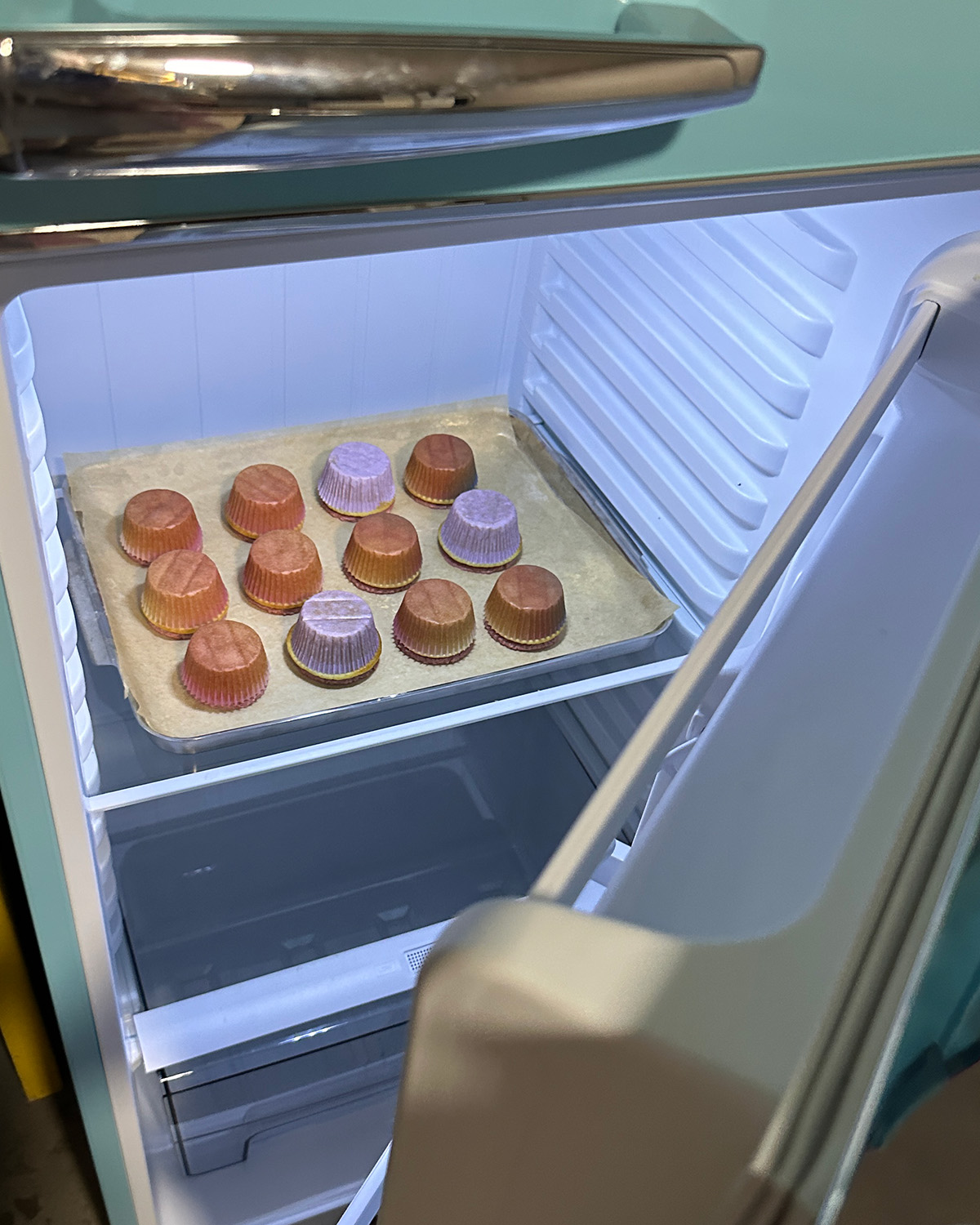 a tray of upside down cupcakes in a fridge.