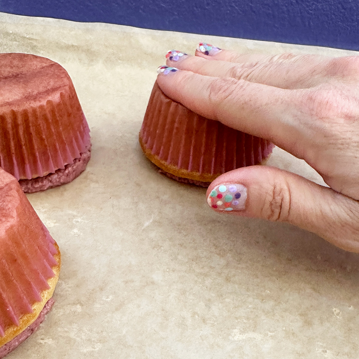 pressing down on the bottom of an upside down cupcake.