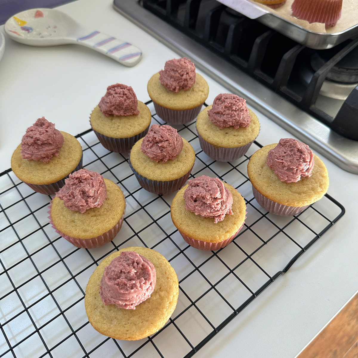 vegan cupcakes with dollops of naturally colored pink strawberry frosting on top.