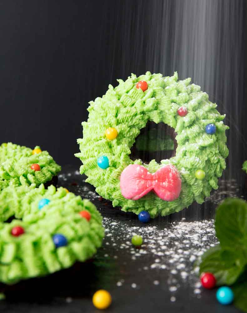 powdered sugar falling onto a mini wreath cake like snow