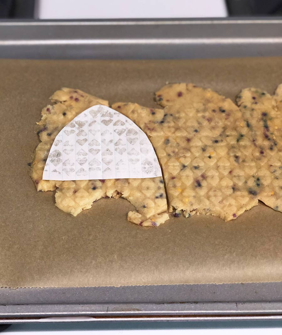 cutting an ear shape out of vegan chocolate chip cookie dough