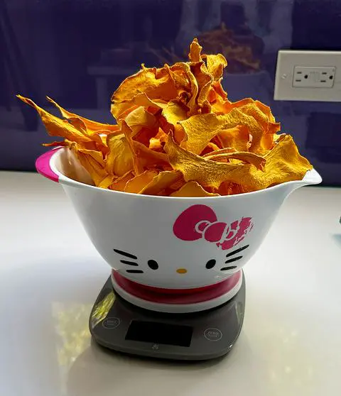 dehydrated pumpkin treats in a large hello kitty bowl.