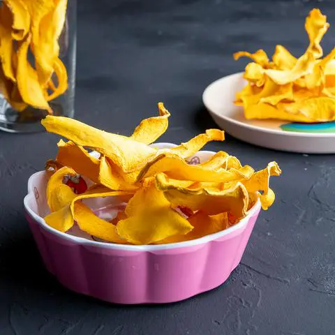 dried pumpkin treats in a pink my melody bowl.