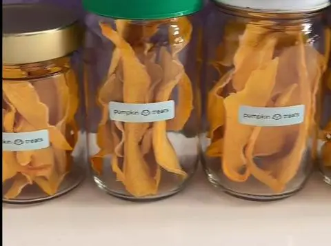 dehydrated pumpkin treats in jars with labels.