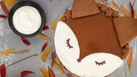 vegan gluten-free pumpkin pie with autumn leaves in the background