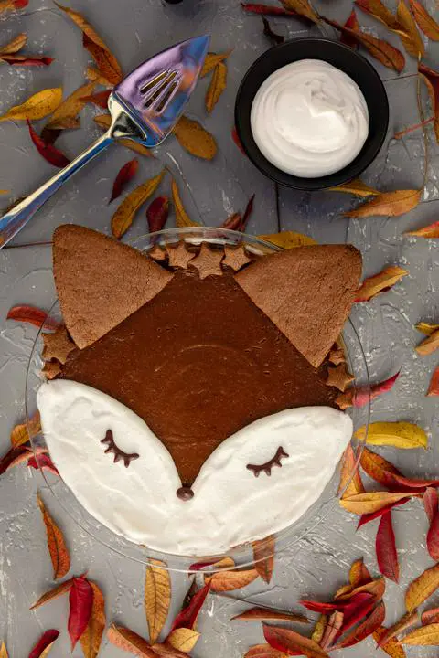 vegan crustless pumpkin pie decorated to look like a fox