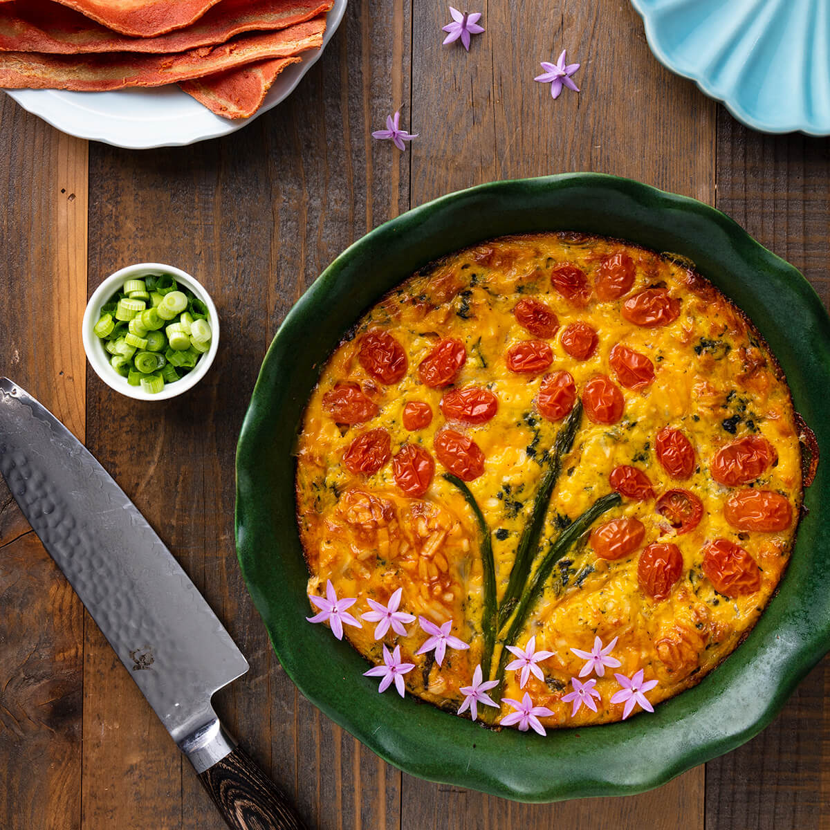 vegan gluten-free quiche made with Just Egg and decorated with tomatoes and asparagus