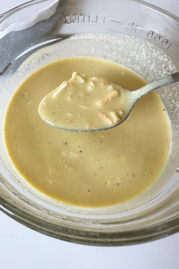 a glass mixing bowl with the wet ingredients