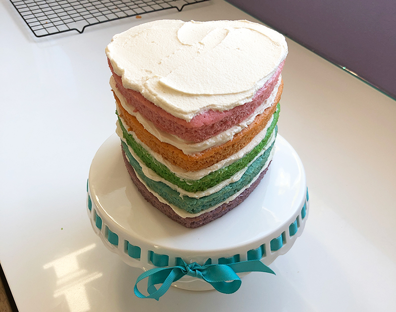 rainbow smash cake assembled and ready to serve