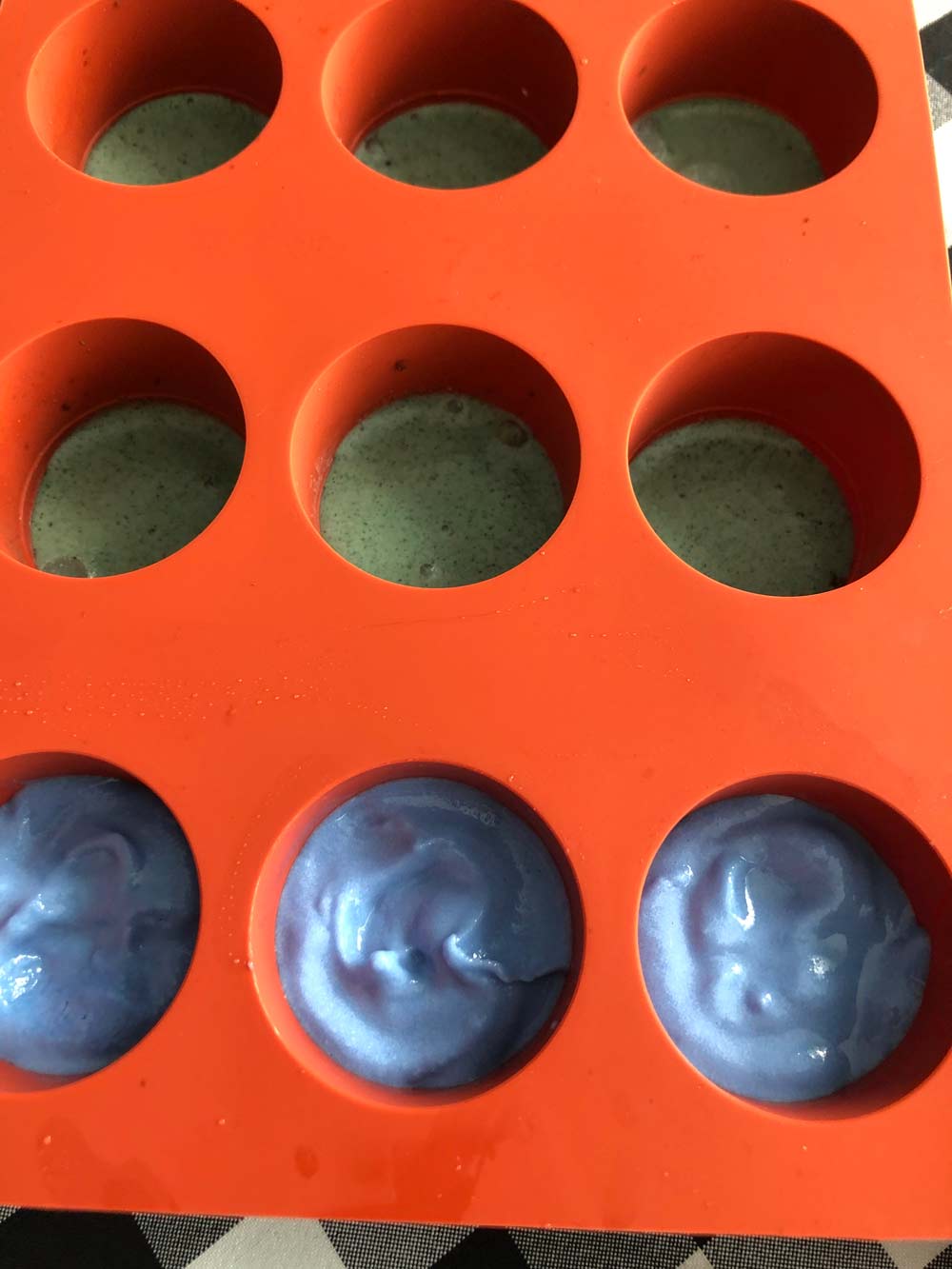 filling silicone molds with vegan rainbow ice cream