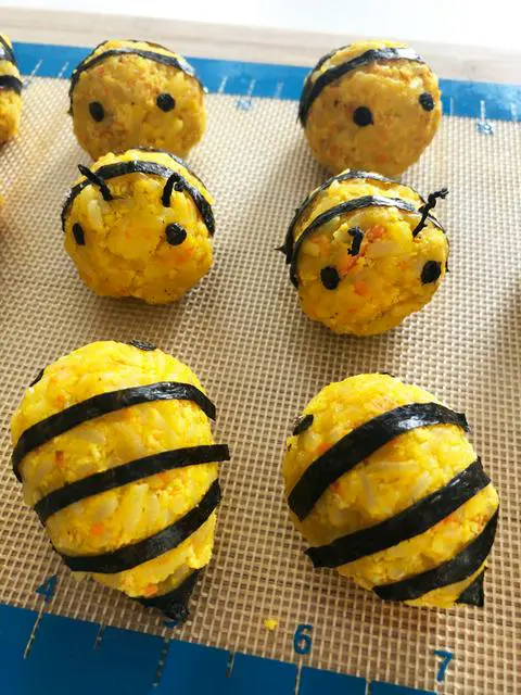 vegan korean rice balls decorated to look like bees