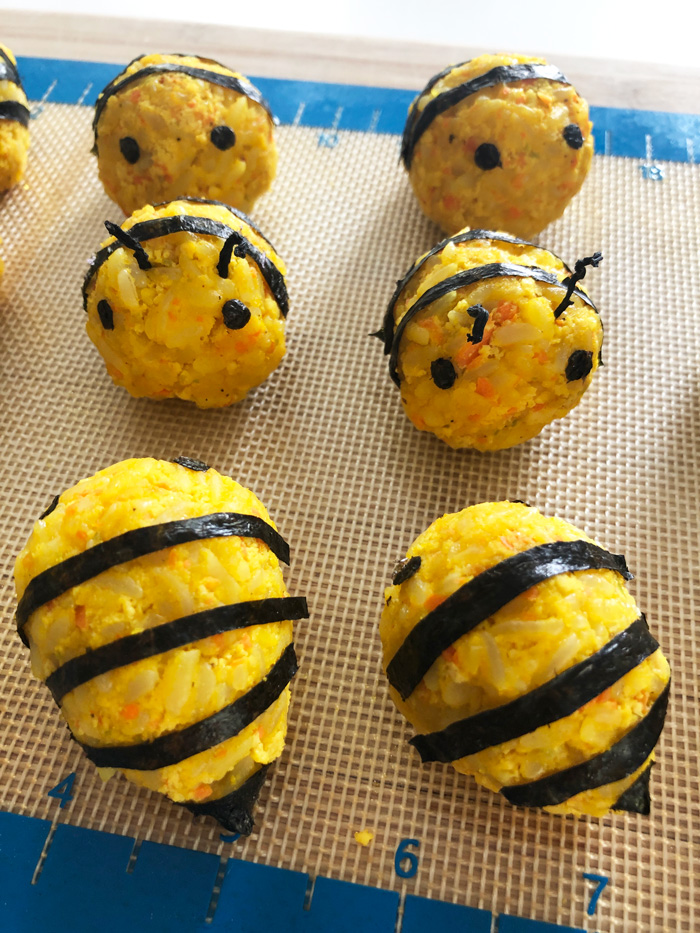 vegan korean rice balls decorated to look like bees