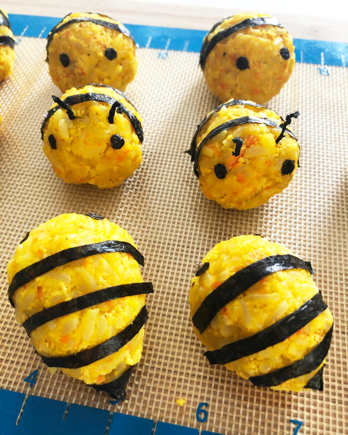 vegan korean rice balls decorated to look like bees