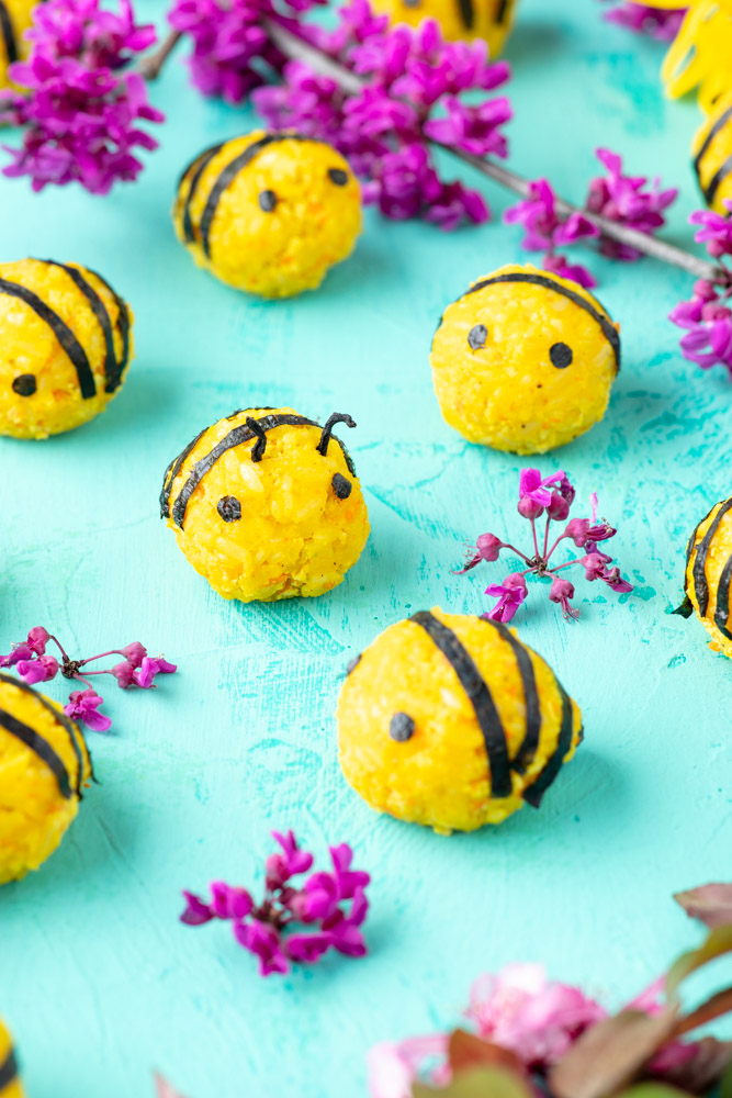 vegan korean rice balls decorated to look like bumble bees