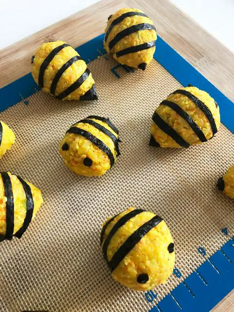 vegan korean rice balls decorated to look like bees