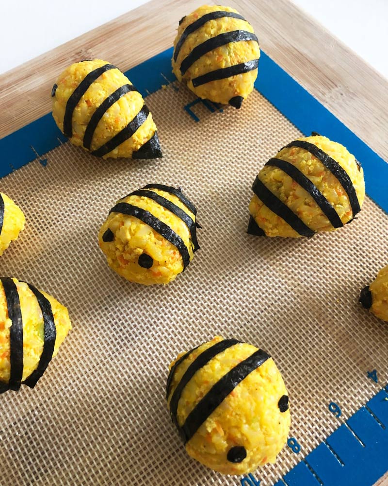 vegan korean rice balls decorated to look like bees