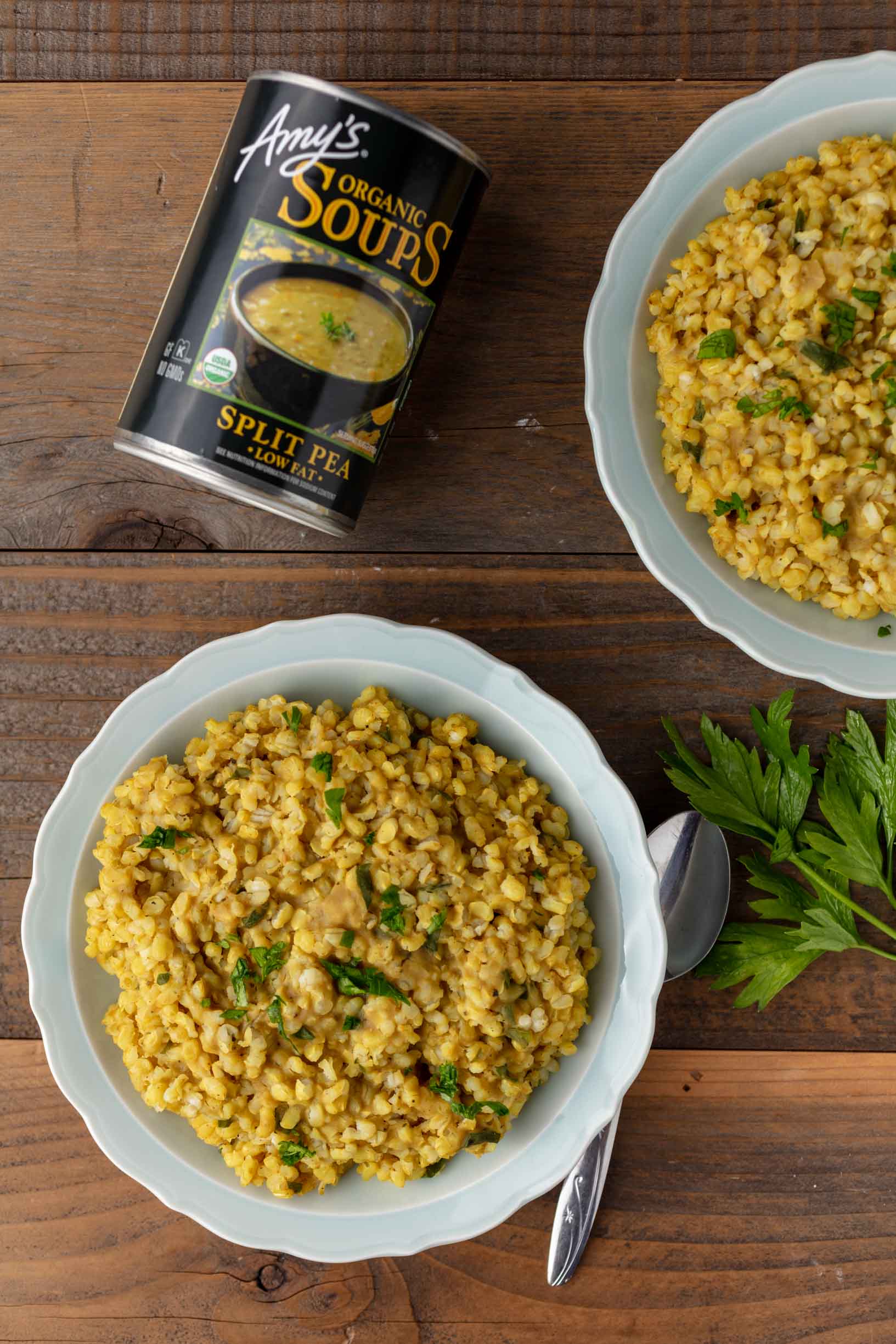 two bowls of vegan risotto on a table with a can of split pea soup