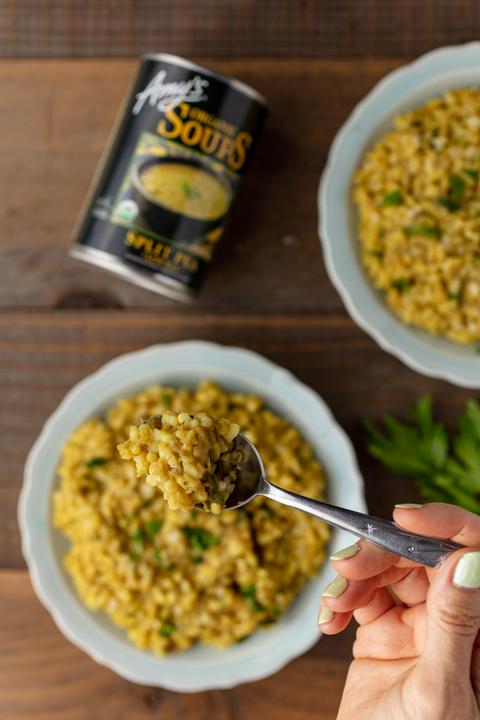 a bite of split pea risotto with a can of split pea soup and 2 bowls of risotto in the background