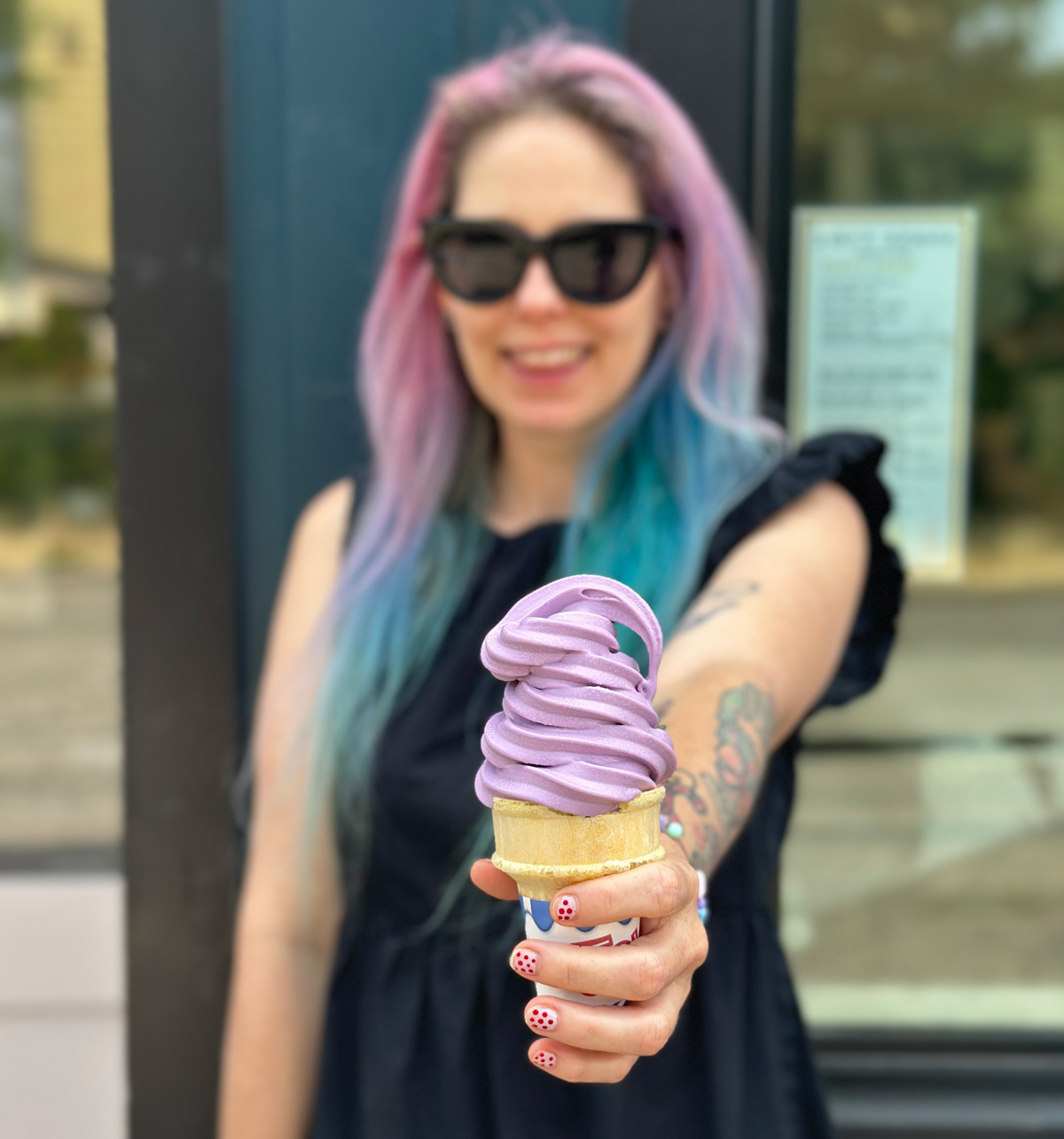 me holding an ice cream cone with purple ube soft serve