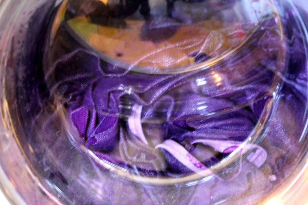 One of the many wash cycles in the purple dye
