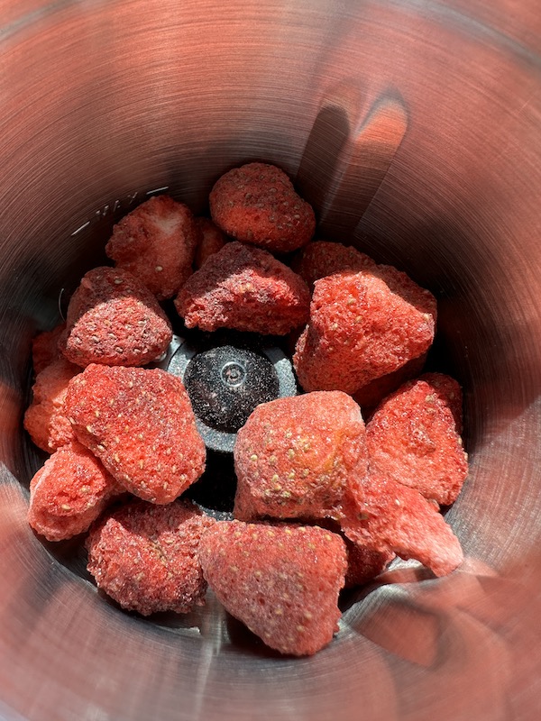 grinding freeze dried strawberries into a powder