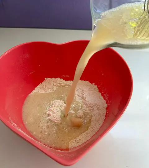 pouring the wet ingredients into the dry ingredients.