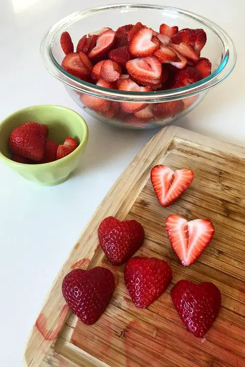 cutting the organic strawberries for the strawberry shortcake parfaits