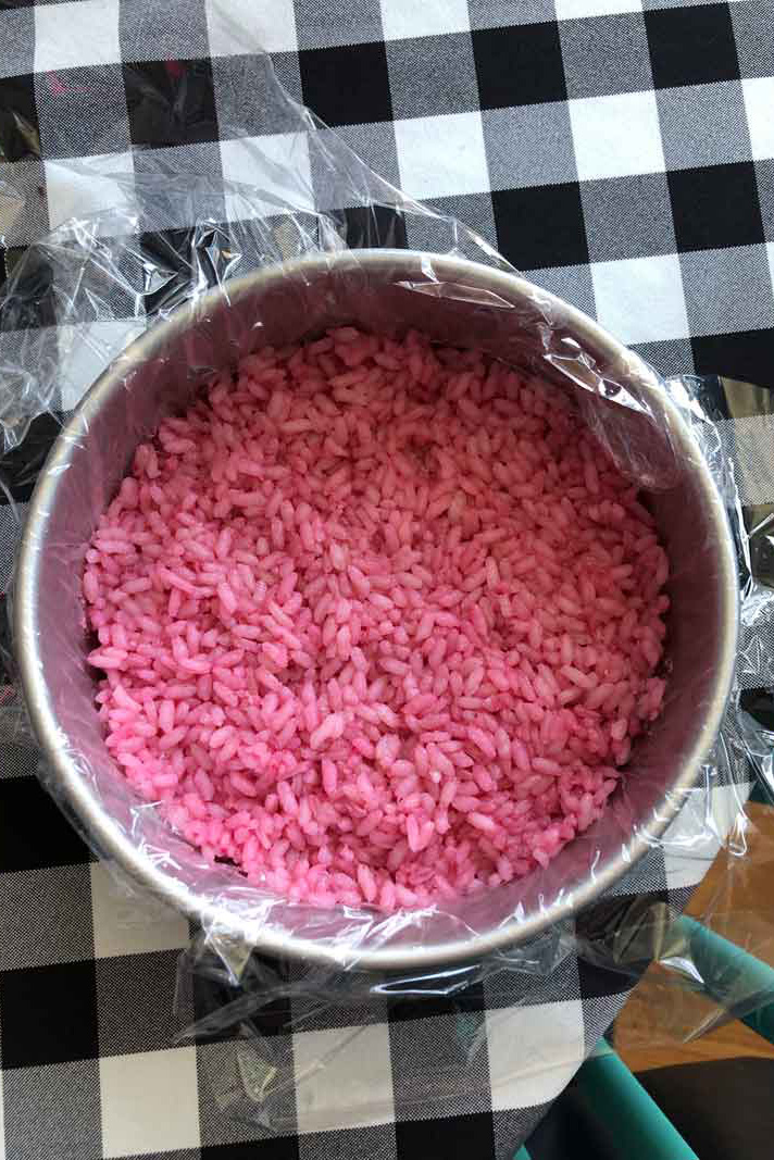 pink sushi rice in a cake pan