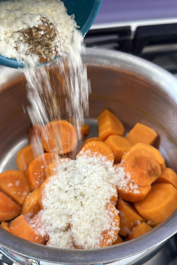 adding spices to the vegan sweet potatoes