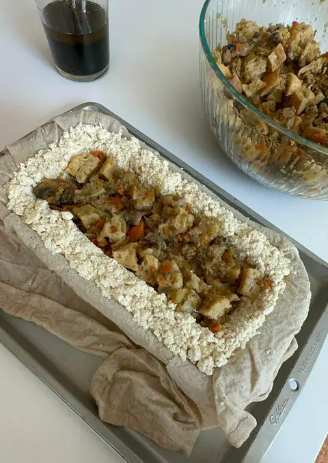 filling the vegan turkey with vegan stuffing